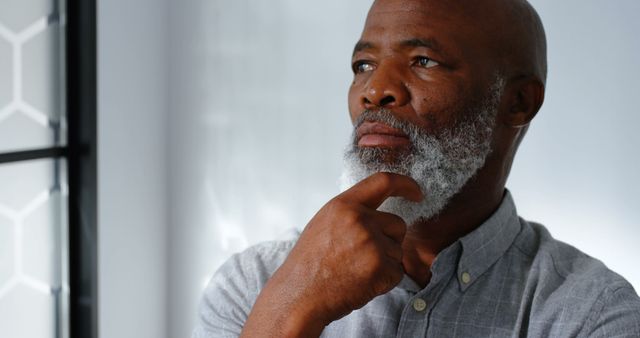 A pensive older African American man standing and thinking - Download Free Stock Images Pikwizard.com