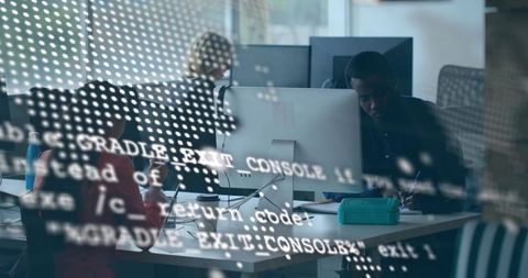Team collaborating in modern office with code reflections on screens