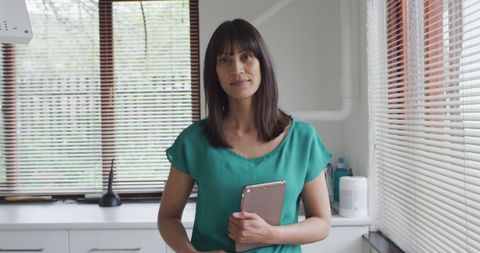 Confident Woman Holding Tablet in Modern Dental Clinic - Download Free Stock Images Pikwizard.com