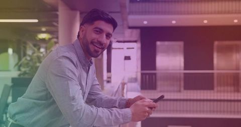 Confident Professional Engaging with Smartphone in Modern Office Setting