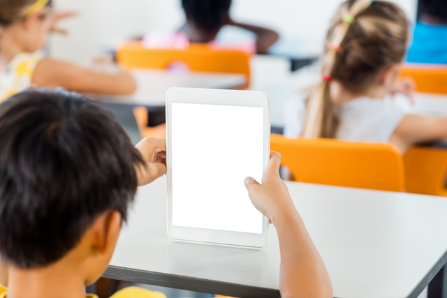 Young Boy Using Transparent Digital Tablet in Classroom - Download Free Stock Videos Pikwizard.com