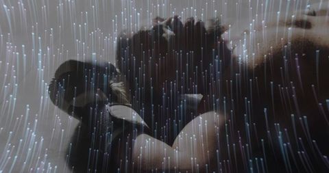 Athletic man lifting dumbbell surrounded by futuristic lights