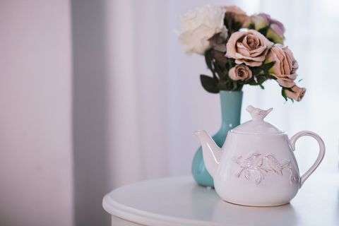 Elegant White Teapot with Floral Bouquet on Table