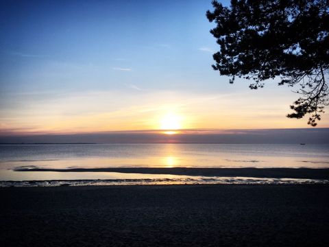 Beautiful Tranquil Beach with Stunning Sunset and Calm Ocean