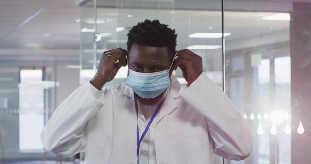 Healthcare Professional Putting on Protective Face Mask in Hospital Ward - Download Free Stock Images Pikwizard.com