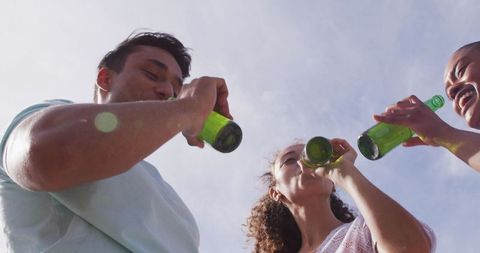 Group of Friends Enjoying Outdoor Drinks Under Clear Sky