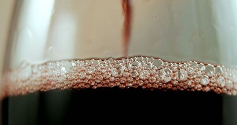 Close-Up of Red Wine with Bubbles in Elegant Glass