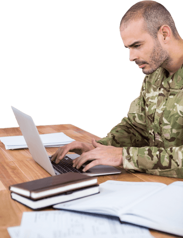 Transparent Male Soldier Focused on Laptop at Wooden Desk