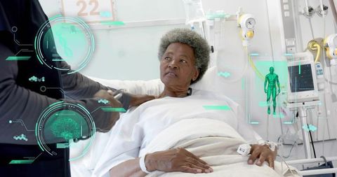 Elderly patient receiving bedside care in hospital with augmented reality health overlays