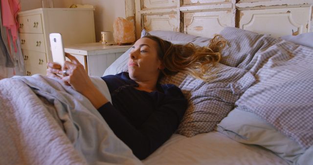 Woman Lying in Bed Relaxed Using Smartphone for Morning Reading - Download Free Stock Images Pikwizard.com