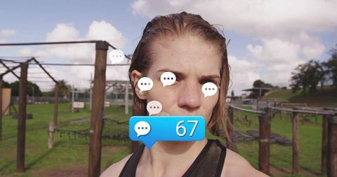 Sweating athlete on outdoor obstacle course receiving social media comments 67
