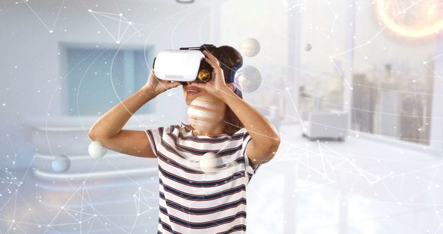 Woman using VR headset exploring virtual solar system. Ideal for educational technology promotions, digital learning tools, and futuristic experiences in marketing materials.