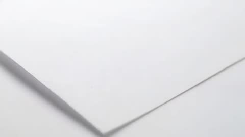 Close-up Video of White Paper Stack Revealing Layered Corner and Diagonal Edge