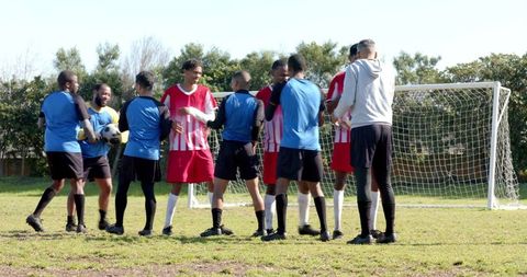 Soccer players shaking hands on field showing sportsmanship