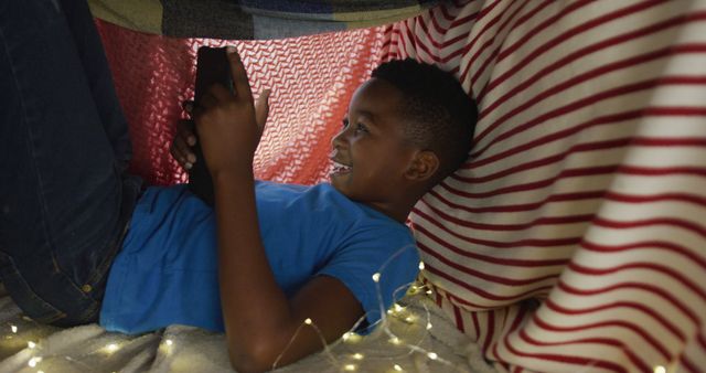 Child Enjoying Inside a Cozy Fort With Smartphone - Download Free Stock Images Pikwizard.com