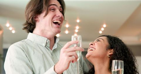 Couple Celebrating with Champagne at Home Party