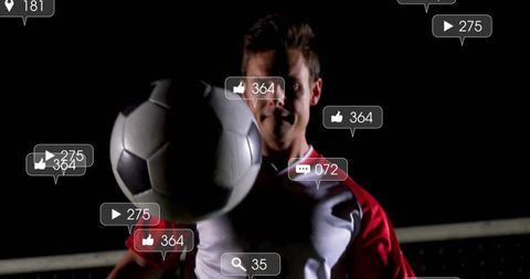 Night soccer player controlling ball under spotlight with social media likes and comments