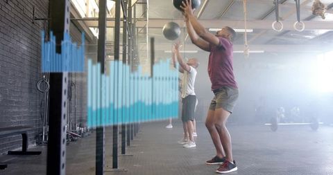 Athlete Throwing Medicine Balls During Intense CrossFit Workout