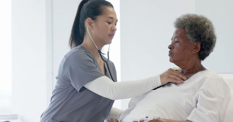 Doctor Listening to Senior Patient's Heart with Stethoscope
