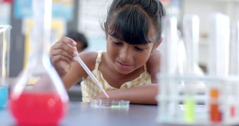Young student engaging in science experiment in classroom