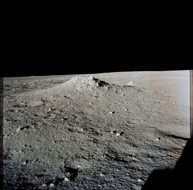 AS12-46-6795 (19-20 Nov. 1969) --- A view of the lunar surface in the vicinity of the Apollo 12 lunar landing site, photographed during the extravehicular activity (EVA) of astronauts Charles Conrad Jr., commander, and Alan L. Bean, lunar module pilot. Conrad and Bean encountered the odd, anthill-shaped mound during their lunar traverse. The two descended in the Apollo 12 Lunar Module (LM) to explore the moon, while astronaut Richard F. Gordon Jr., command module pilot, remained with the Command and Service Modules (CSM) in lunar orbit.