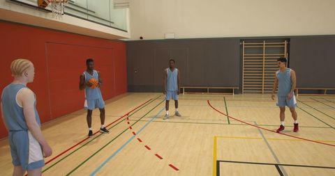 Diverse Basketball Team Practicing Passing in Gymnaisum