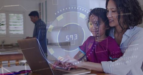 Mother guiding daughter on laptop with futuristic HUD overlay in bright kitchen daylight