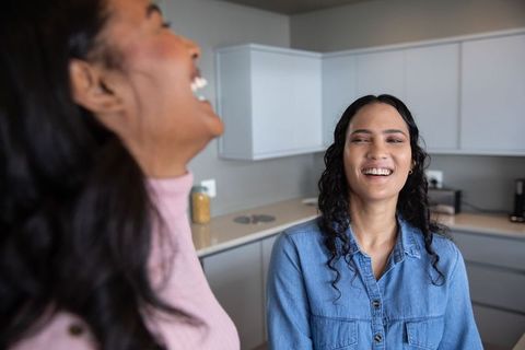 Joyful Moment Shared by Friends in Modern Kitchen