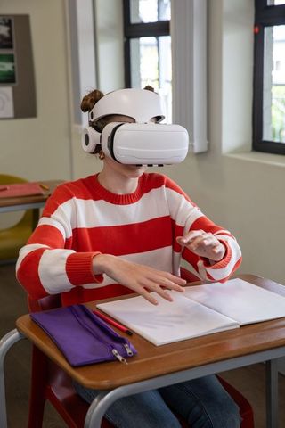 Teen student experiencing virtual reality in classroom setting