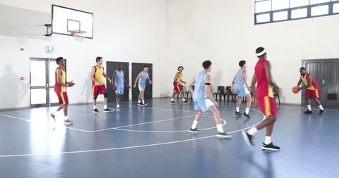 Energetic basketball match on indoor court with diverse players