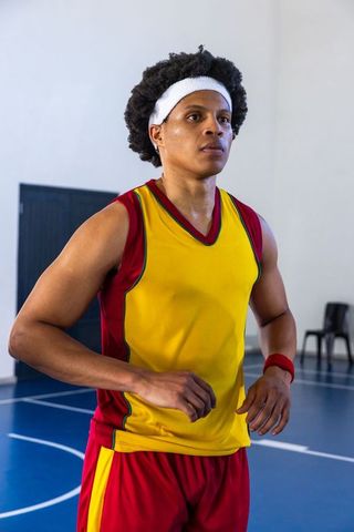 Determined Athlete Preparing for Game in Indoor Gymnasium