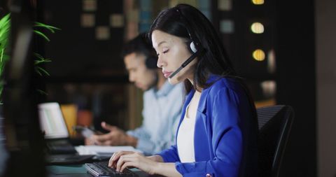 Business Professional on Headset Working Late in Office