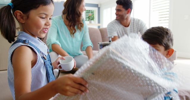 Family Enjoying Unpacking in New Home Together - Download Free Stock Images Pikwizard.com