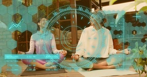 Mother daughter meditating with augmented reality hud on sunlit wooden deck
