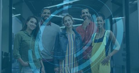 Innovative team collaborating with blue holographic interface in modern office