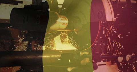 Metal pipe grinding in workshop showering sparks