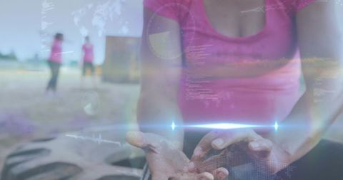 Woman cupping hands during outdoor group fitness training with holographic overlay