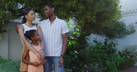 Diverse Family Embracing Outdoors in Lush Garden Setting