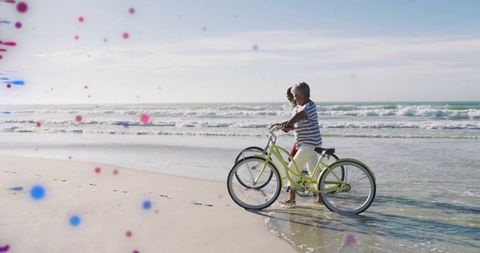 Senior Couple Walking Bikes on Peaceful Beach