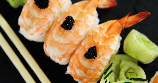 Elegantly presented shrimp sushi topped with caviar is paired with green wasabi, showcasing a traditional Japanese cuisine. The vibrant colors and arrangement highlight the artistry and attention to detail in sushi preparation.