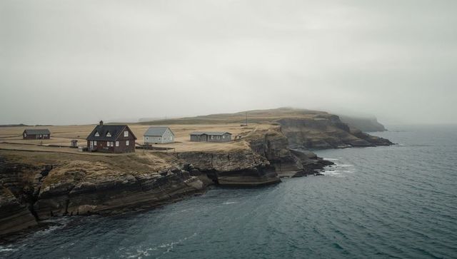 Clifftop cottages overlooking rugged North Atlantic coastline, moody overcast atmosphere
