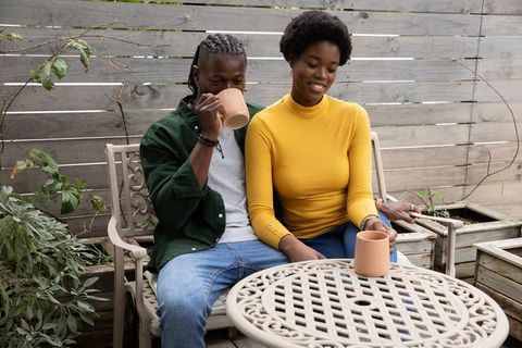 Couple enjoying coffee together in outdoor garden patio