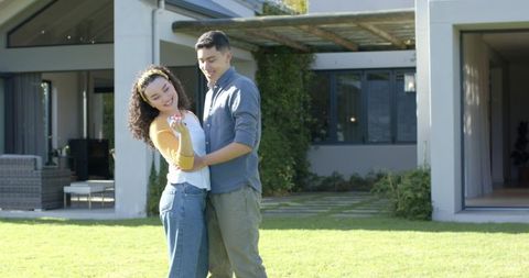 Happy Couple Celebrating Engagement on Sunny Lawn