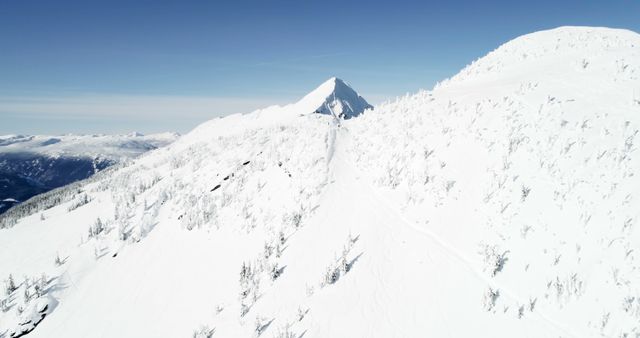Aerial View of Snow-Covered Mountain Range Under Clear Blue Sky - Download Free Stock Images Pikwizard.com