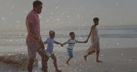 Family Enjoying Relaxed Stroll Along Seashore