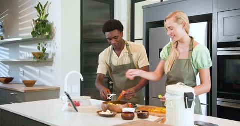 Couple cooking together in modern kitchen for a healthy lifestyle