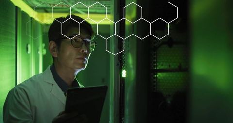Asian scientist analyzing data in high-tech server room