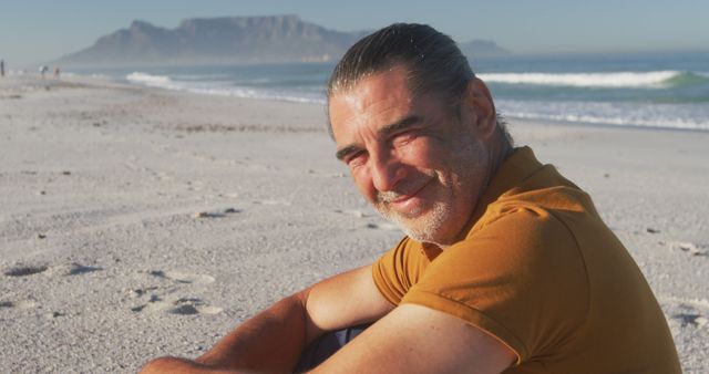 Portrait of happy senior caucasian man smiling on beach. Senior lifestyle, realxation, nature, free time and vacation.