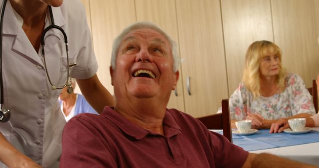 Elderly Man Smiling with Healthcare Worker at Nursing Home - Download Free Stock Images Pikwizard.com