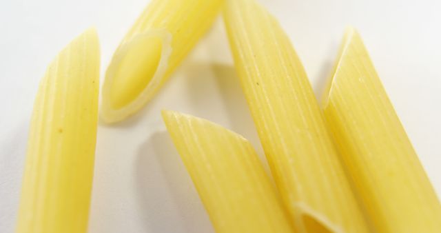 Close-up of Raw Penne Pasta on White Background - Download Free Stock Images Pikwizard.com